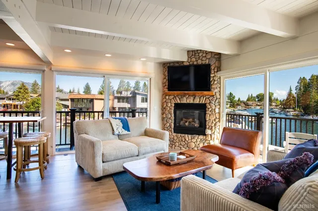 a living room with furniture a fireplace and a large window