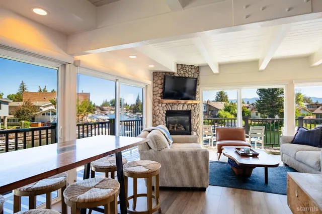 a kitchen with stainless steel appliances granite countertop wooden floors and view living room