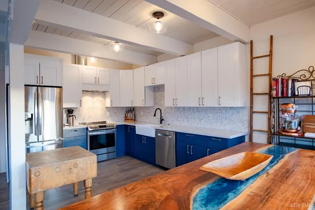 a kitchen with a sink cabinets and wooden floor