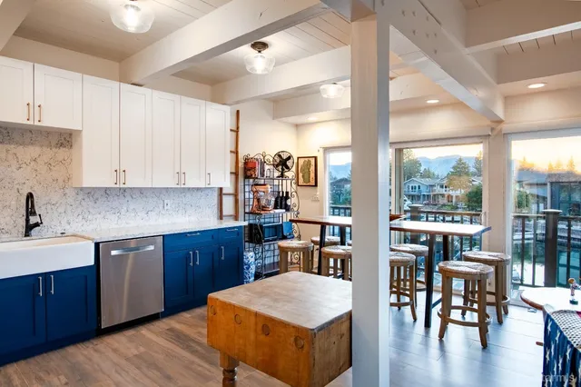 a kitchen with granite countertop a sink stainless steel appliances and cabinets