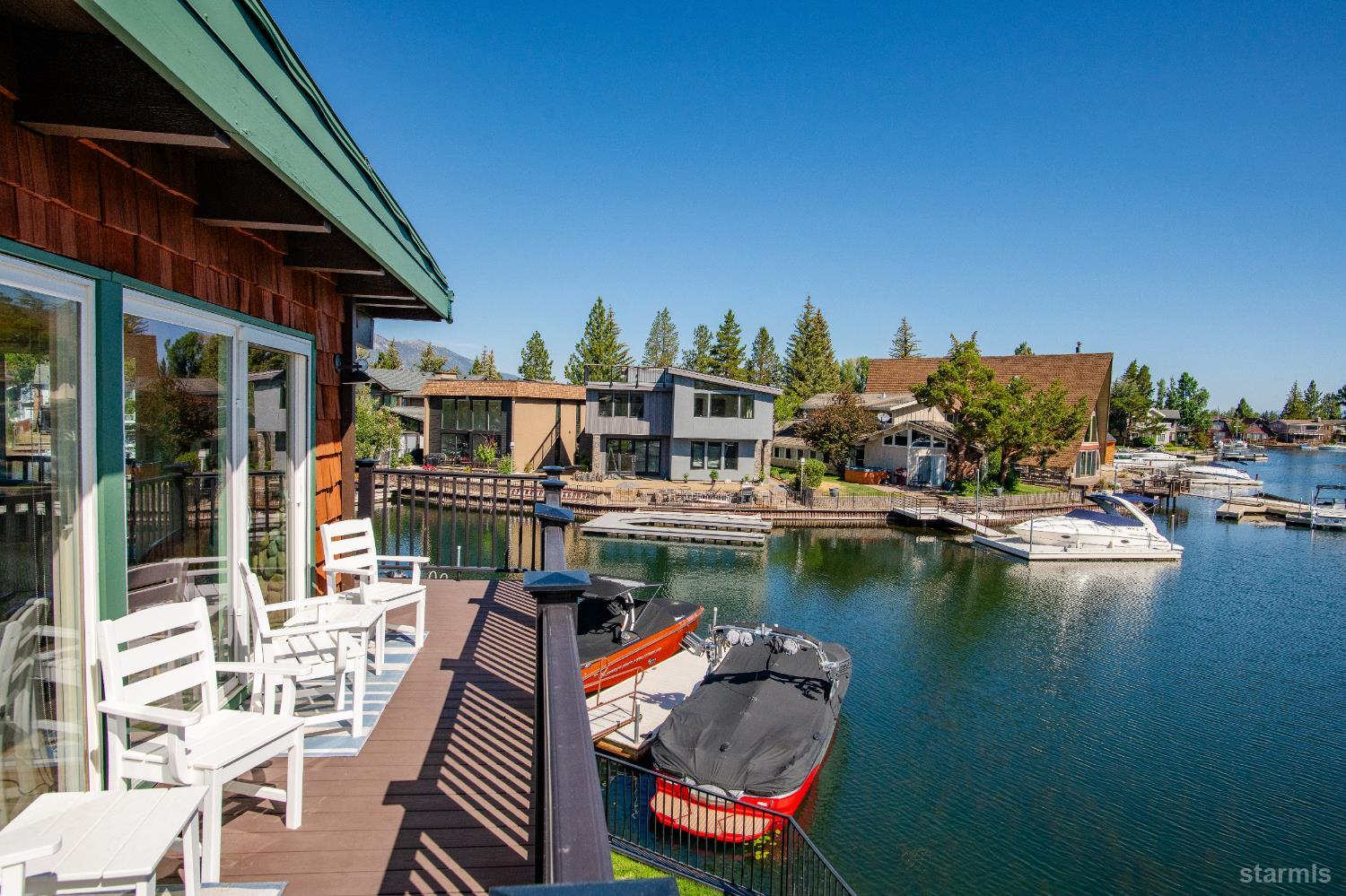 2081 Venice Drive, Unit 280 South Lake Tahoe, CA 96150 - Photo 35 of 37 a view of a lake with couches chairs and a table