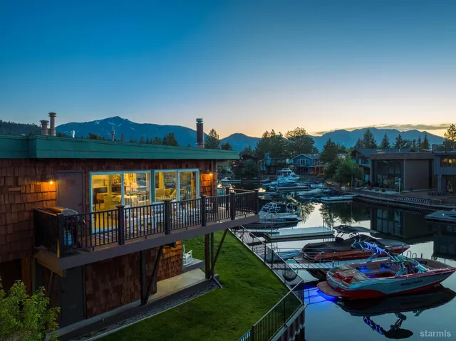 a living room with furniture a fireplace and a floor to ceiling window