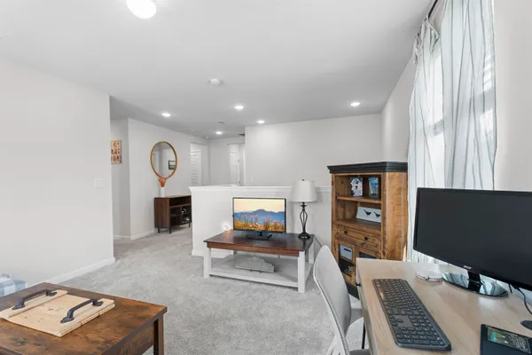 an entryway in wooden floor and a workspace