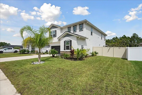 a front view of a house with a yard and garage