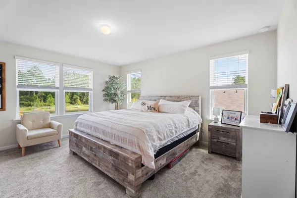 a bedroom with a bed and a potted plant