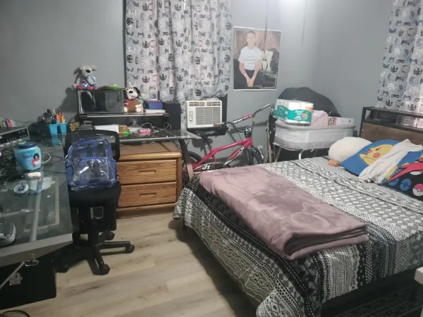 a bed room with a bed window and dresser