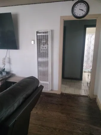 a bedroom with a bed and a flat tv screen on the dresser