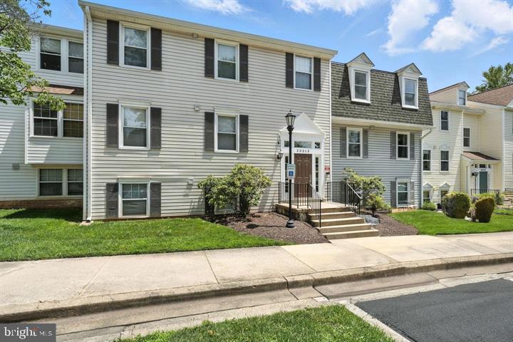 20315 Beaconfield Terrace, Unit 202 Germantown, MD 20874 - Photo 1 of 25 a front view of a house with a yard and garage
