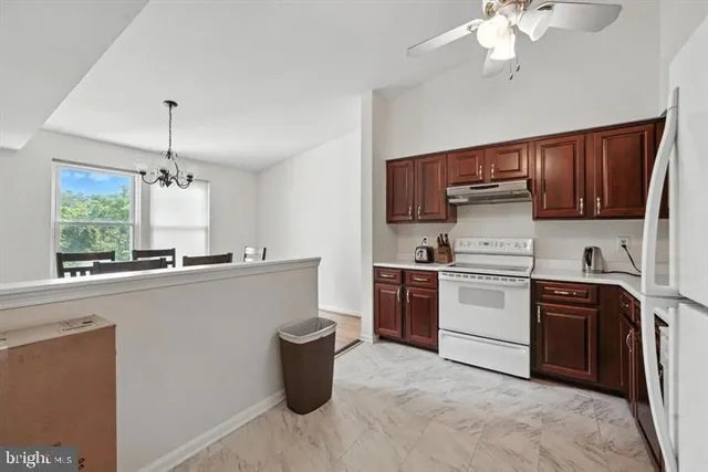 a kitchen with a stove a sink and a refrigerator