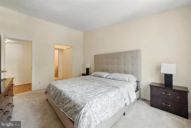 a bedroom with a bed and a night stand