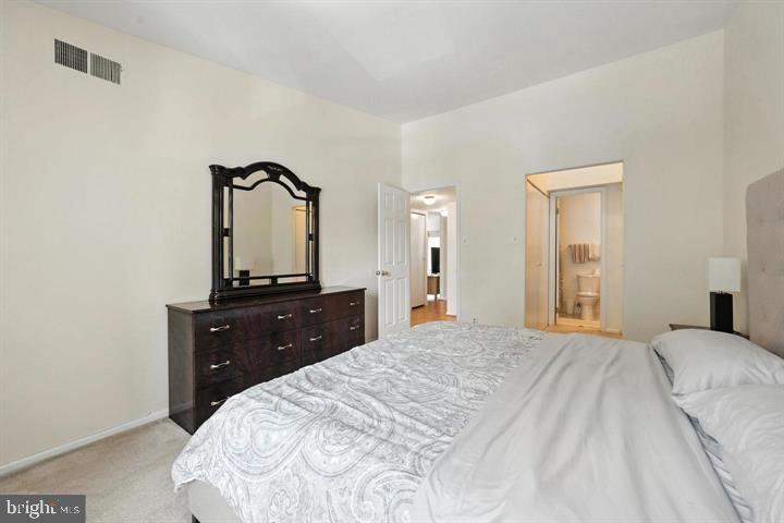 20315 Beaconfield Terrace, Unit 202 Germantown, MD 20874 - Photo 19 of 25 a bedroom with a bed and a dresser