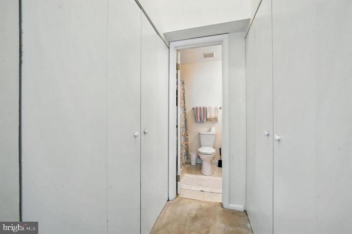 20315 Beaconfield Terrace, Unit 202 Germantown, MD 20874 - Photo 20 of 25 a bathroom with a glass shower door