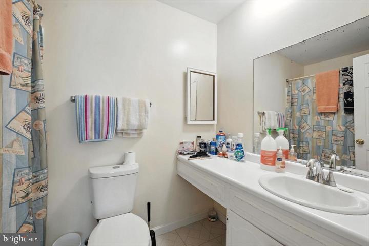 20315 Beaconfield Terrace, Unit 202 Germantown, MD 20874 - Photo 21 of 25 a bathroom with a sink toilet and shower