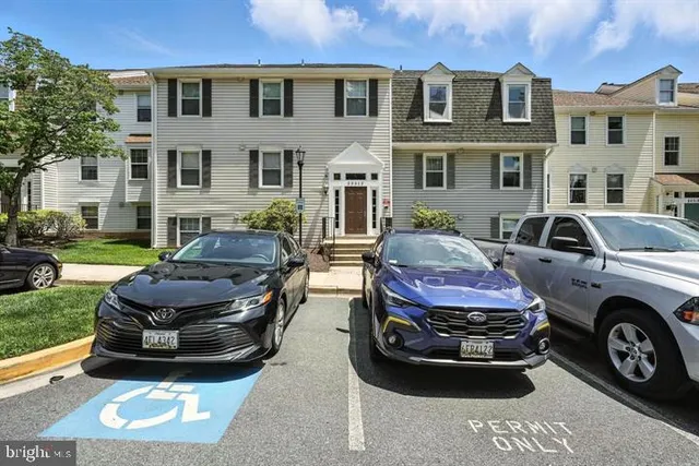 a view of a car parked in front of a brick house