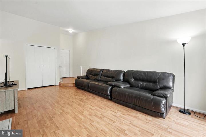 20315 Beaconfield Terrace, Unit 202 Germantown, MD 20874 - Photo 5 of 25 a living room with a couch and a flat screen tv