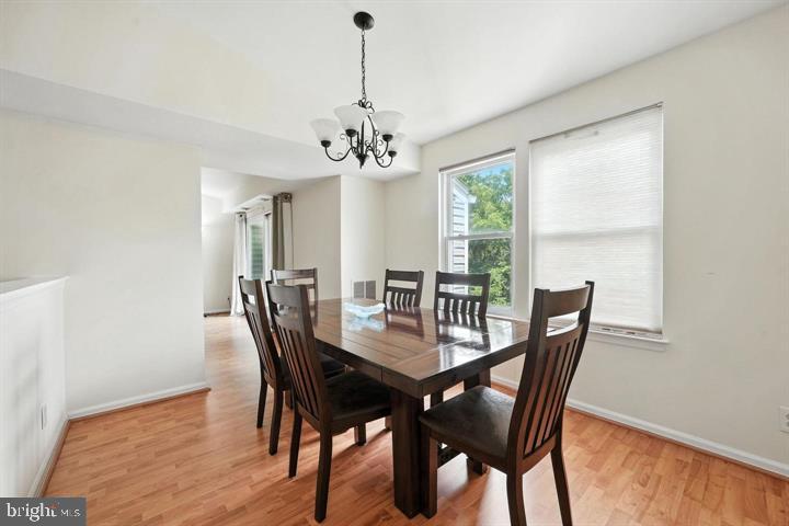 20315 Beaconfield Terrace, Unit 202 Germantown, MD 20874 - Photo 8 of 25 a view of a dining room with furniture window and wooden floor