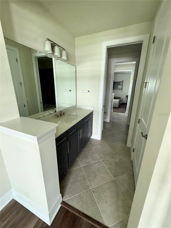 8441 Pk Clf Way Orlando, FL 32836 - Photo 29 of 59 a bathroom with a double vanity sink and mirror