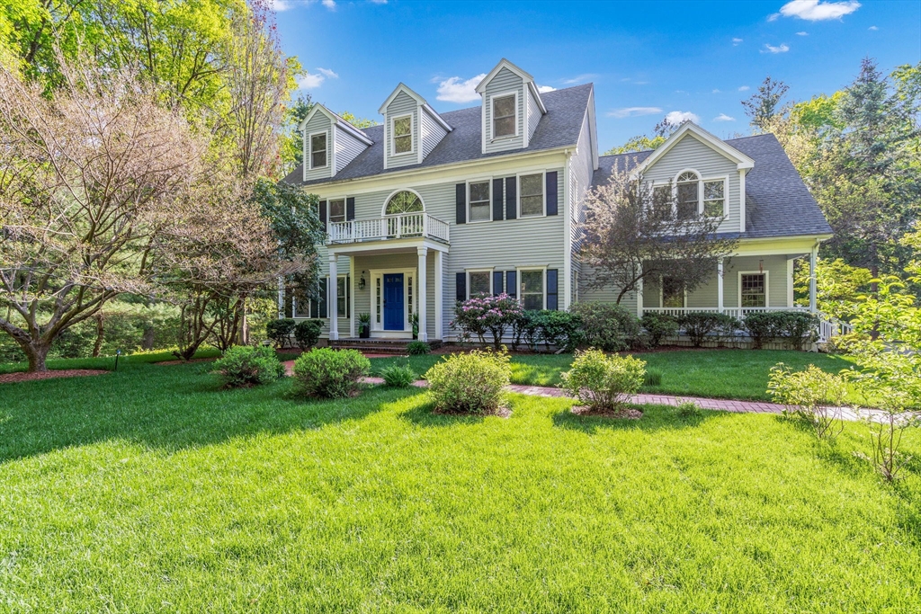 a front view of a house with a yard table and chairs