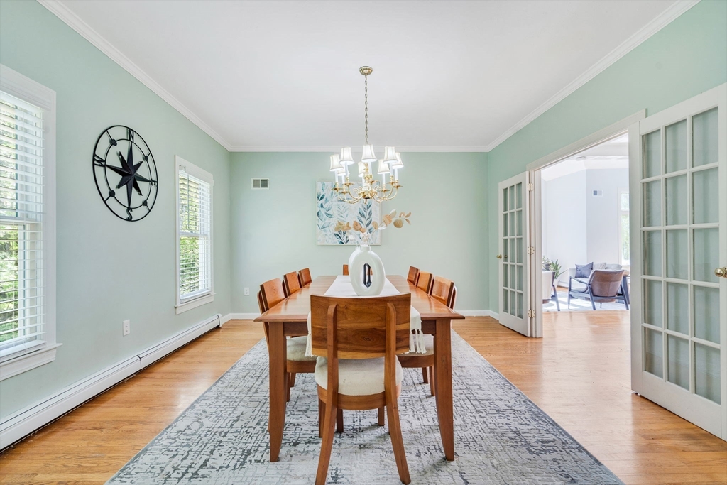 153 Walpole Street Dover, MA 02030 - Photo 12 of 42 a dining room with furniture a rug and a chandelier