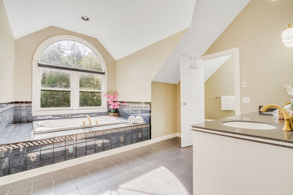 153 Walpole Street Dover, MA 02030 - Photo 19 of 42 a spacious bedroom with a large window and a couch