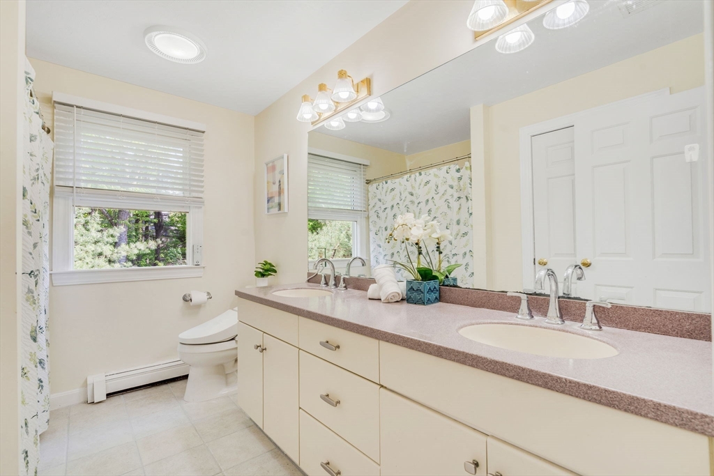 153 Walpole Street Dover, MA 02030 - Photo 24 of 42 a bathroom with a granite countertop sink mirror and a bathtub