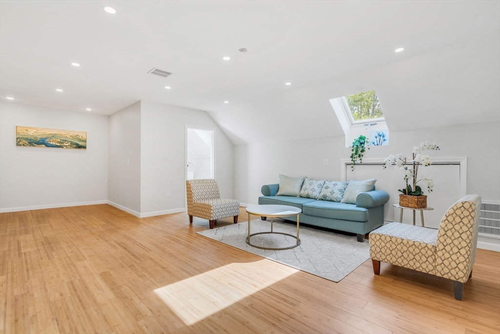 153 Walpole Street Dover, MA 02030 - Photo 25 of 42 a living room with furniture and a wooden floor