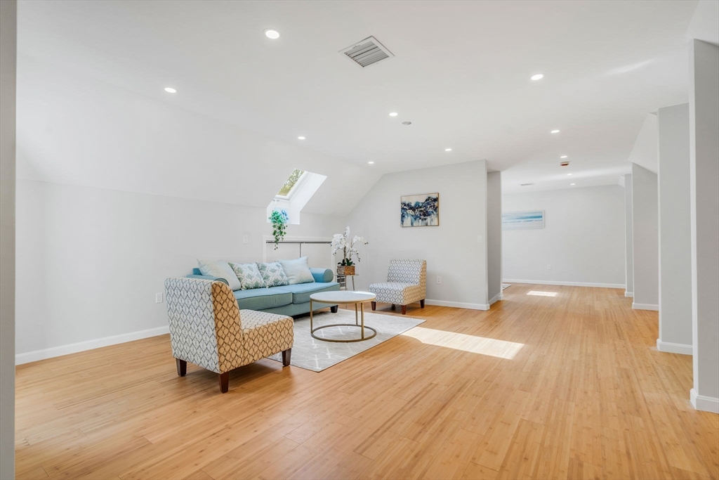 153 Walpole Street Dover, MA 02030 - Photo 26 of 42 a living room with furniture and a wooden floor