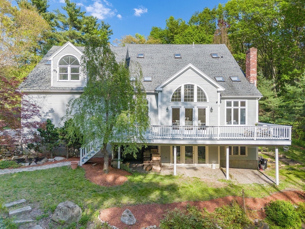153 Walpole Street Dover, MA 02030 - Photo 36 of 42 a front view of a house with a garden and plants