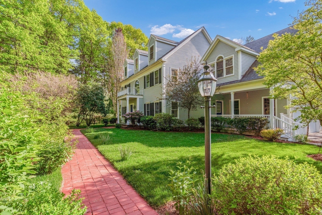 153 Walpole Street Dover, MA 02030 - Photo 38 of 42 a front view of a house with garden