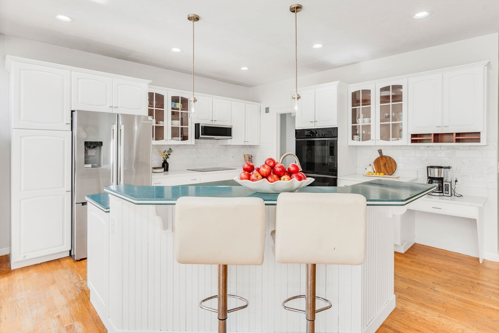 153 Walpole Street Dover, MA 02030 - Photo 6 of 42 a kitchen with stainless steel appliances granite countertop a refrigerator a oven a sink dishwasher and white cabinets with wooden floor