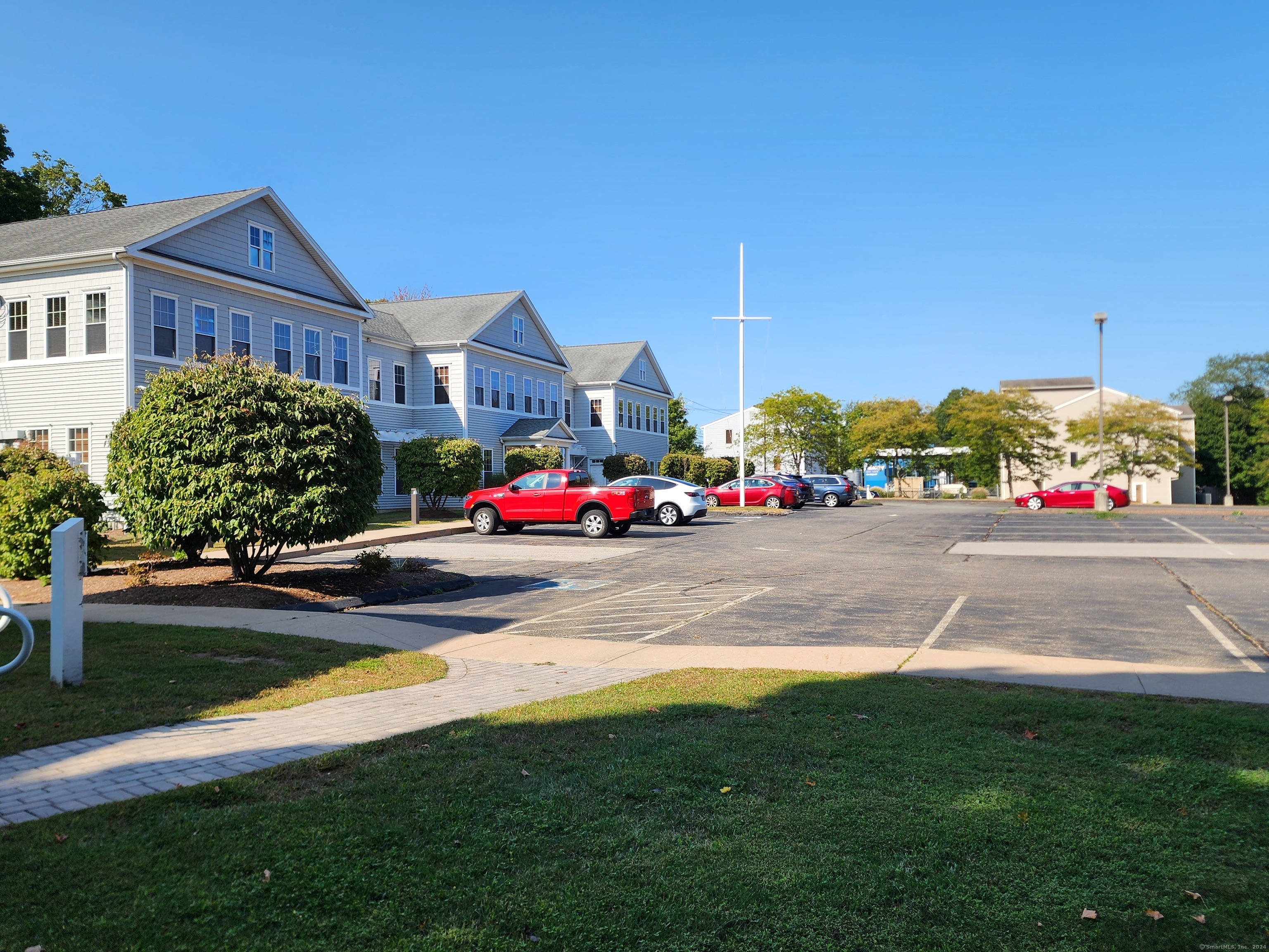 a view of street with houses and cars parked in front of it