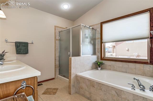 9737 Rockingham Drive Peyton, CO 80831 - Photo 13 of 28 ~Beautiful Master Bath with a large soaking tub, a separate shower, and nice tile accents~