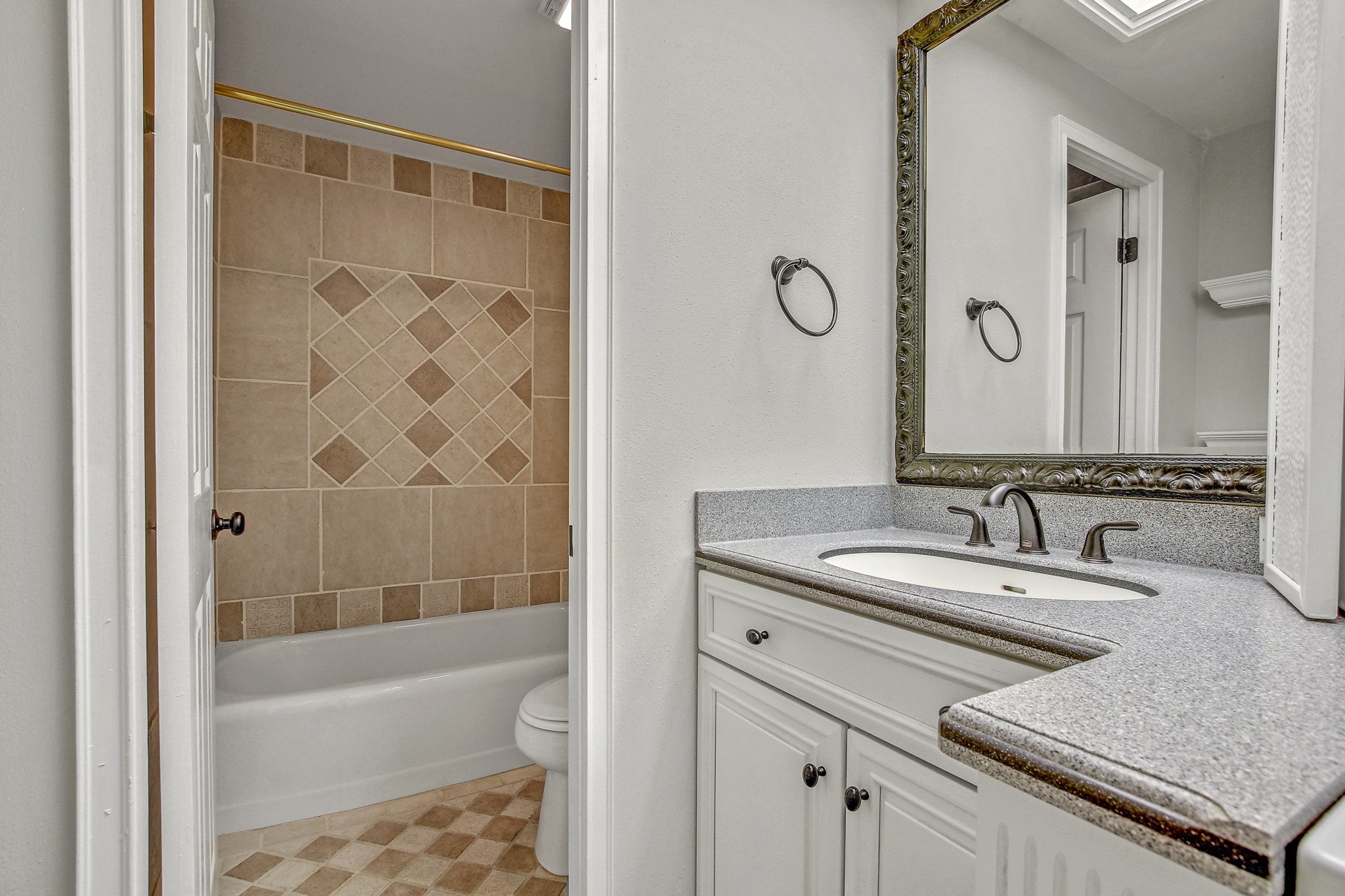 1801 Lavaca Street, Unit 5F Austin, TX 78701 - Photo 14 of 37 a bathroom with a granite countertop sink mirror toilet and bathtub