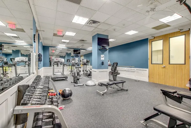 a dining room with furniture a rug and wooden floor