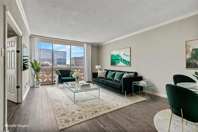 a living room with furniture large window and wooden floor