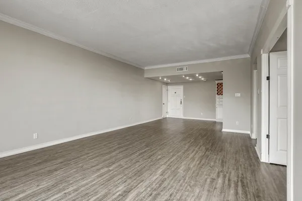 a view of an empty room and wooden floor