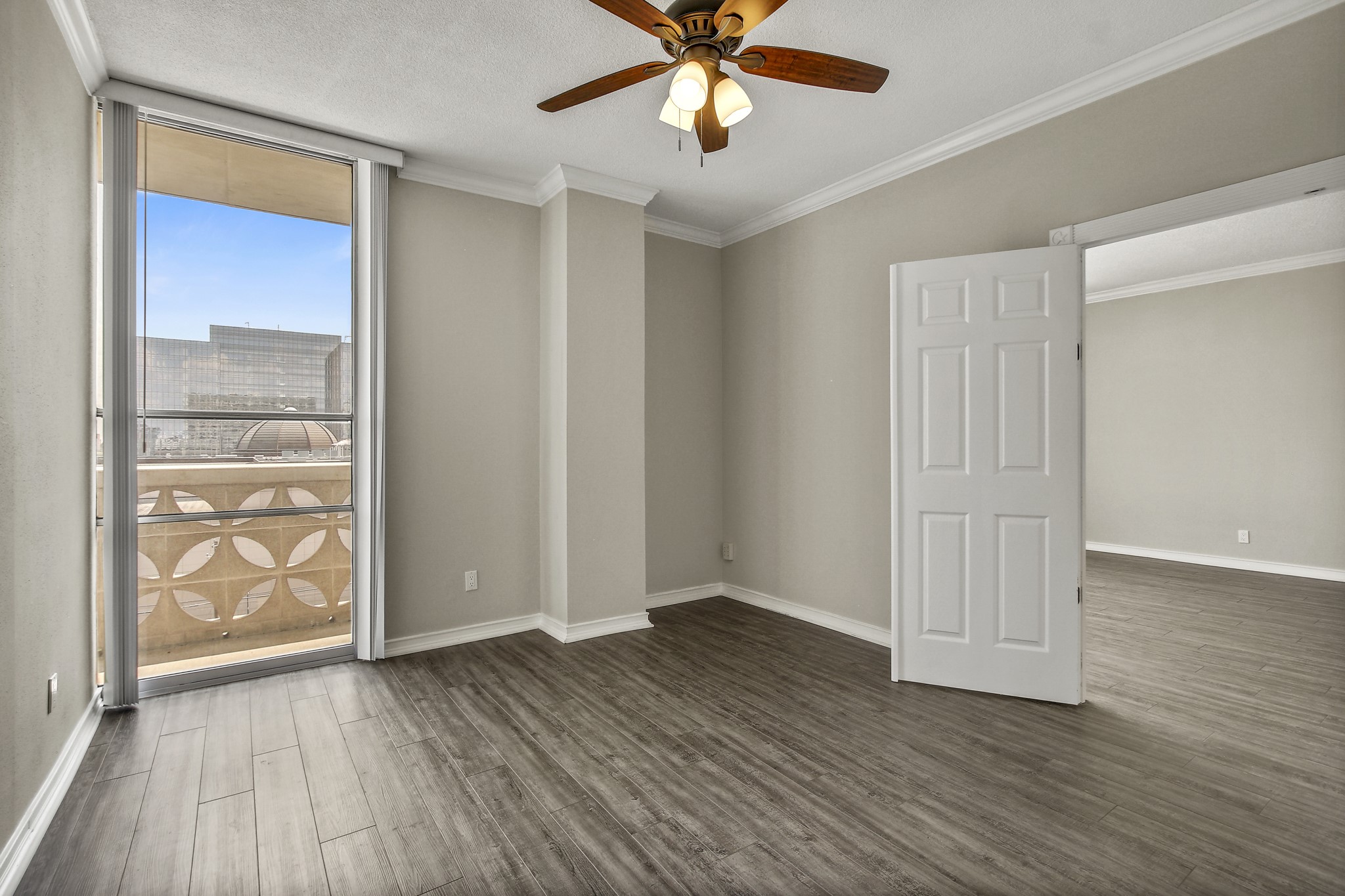 1801 Lavaca Street, Unit 5F Austin, TX 78701 - Photo 10 of 37 an empty room with wooden floor closet and windows
