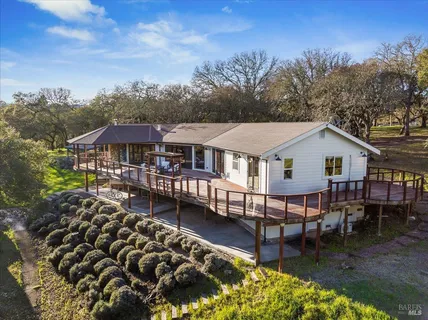 a aerial view of a house with swimming pool and sitting area