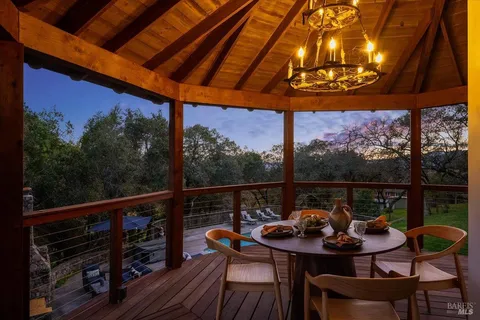 a view of a chairs and table in the balcony