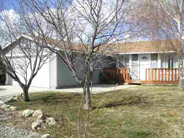 10073 Albite Street Reno, NV 89506 - Photo 1 of 1 a tree in front of a white house