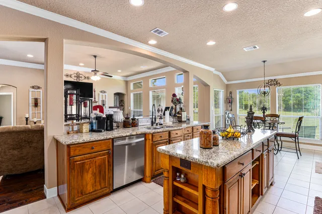 a kitchen with a stove kitchen island furniture and a view of living room