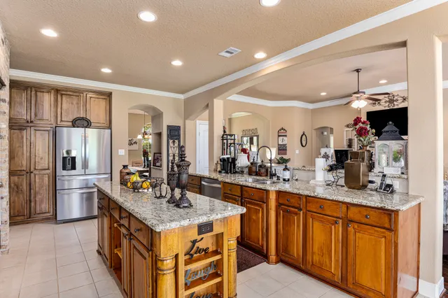 a kitchen with stainless steel appliances granite countertop a stove and a sink