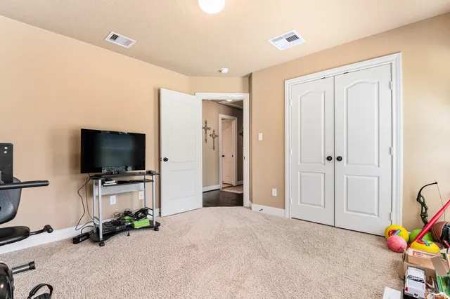 a view of a livingroom with entryway flat screen tv