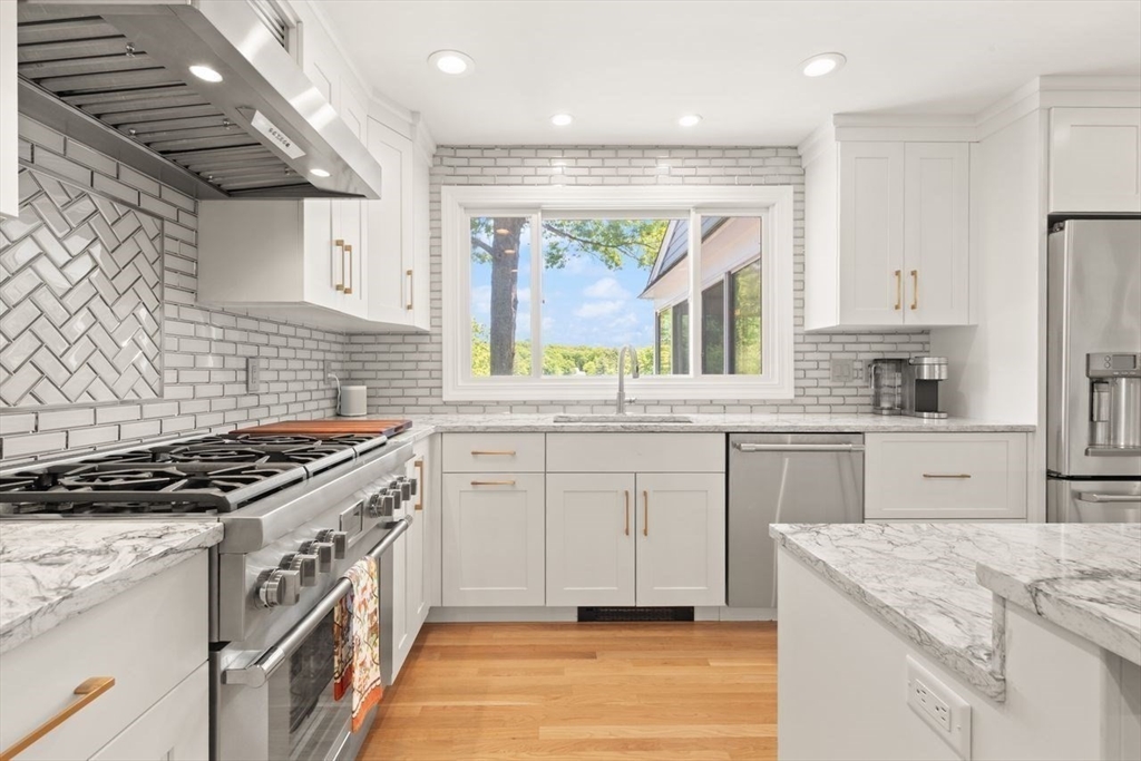 9 Bragg Road Foxboro, MA 02035 - Photo 15 of 42 a kitchen with granite countertop cabinets stainless steel appliances and a counter space