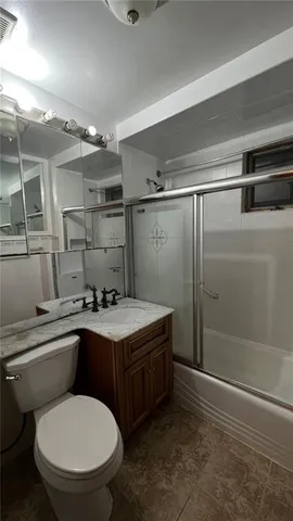 a bathroom with a toilet sink and shower