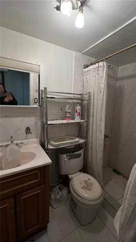 a bathroom with a toilet a sink and shower