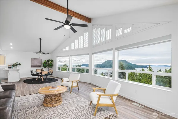 a living room with patio furniture and a large window