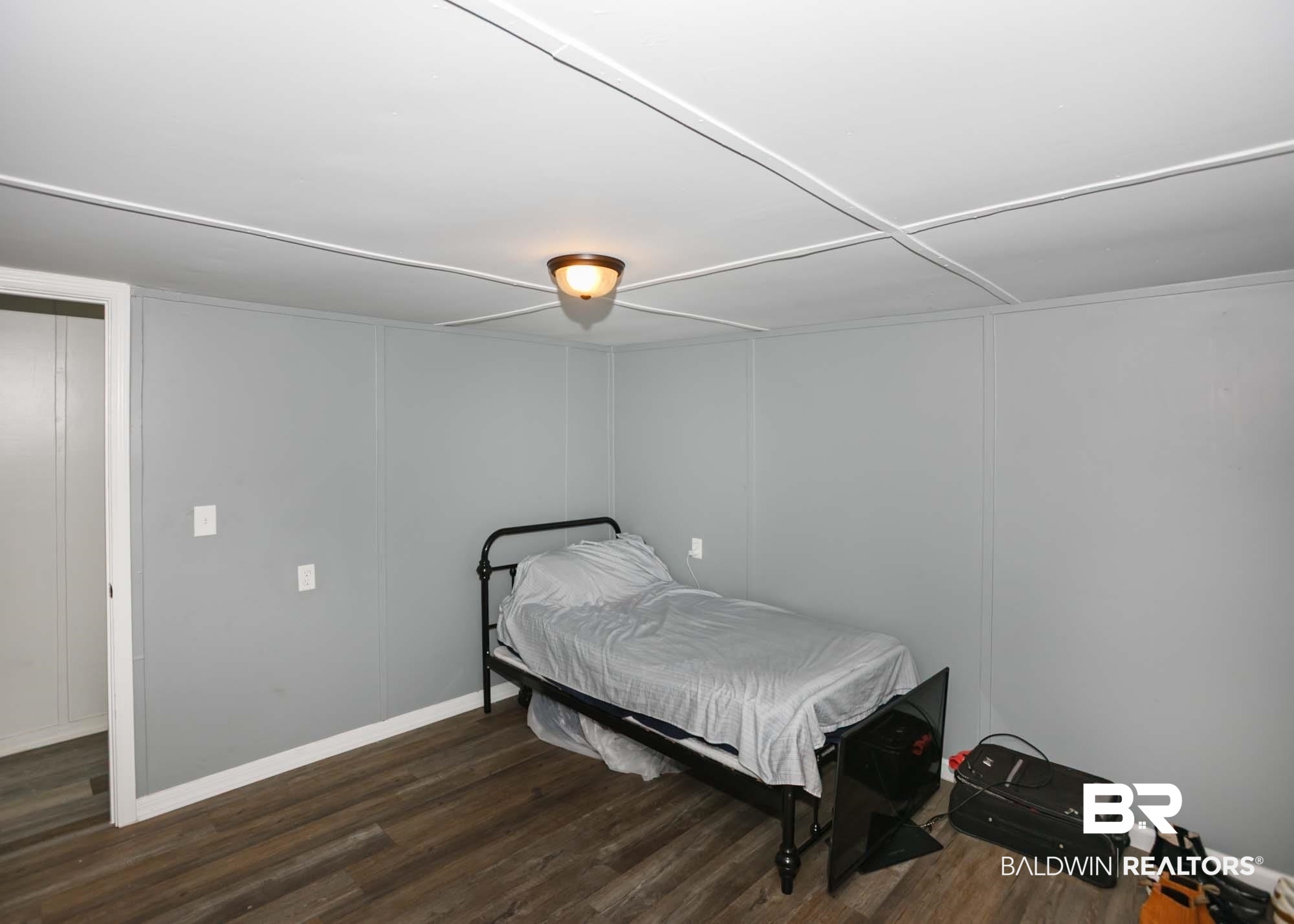 11998 Workman Avenue Foley, AL 36535 - Photo 23 of 59 Bedroom featuring wood finished floors and baseboards