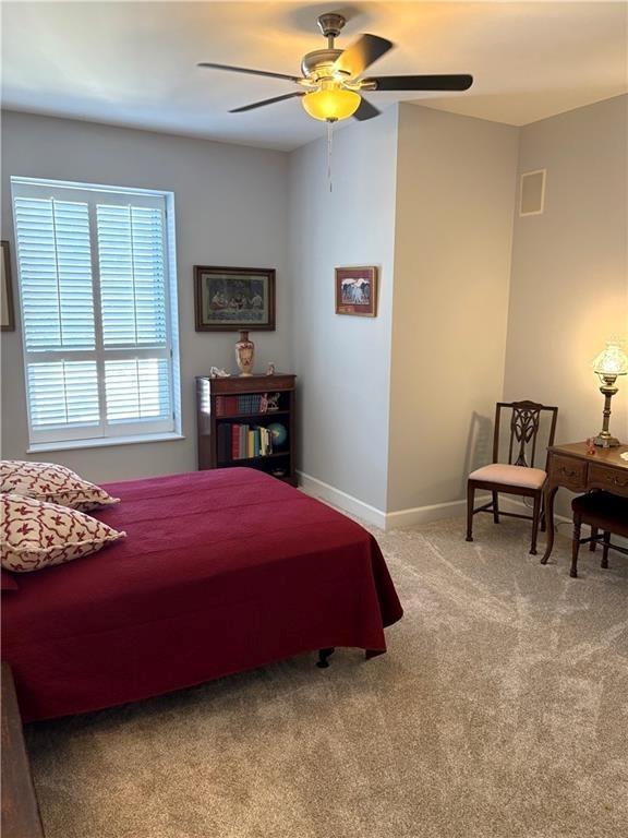 2626 Peachtree Road Northwest, Unit 704 Atlanta, GA 30305 - Photo 13 of 23 a bedroom with a bed table and chair