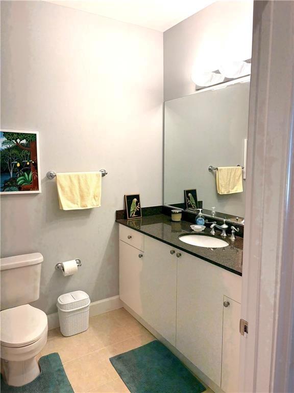 2626 Peachtree Road Northwest, Unit 704 Atlanta, GA 30305 - Photo 14 of 23 a bathroom with a granite countertop sink a toilet and a mirror